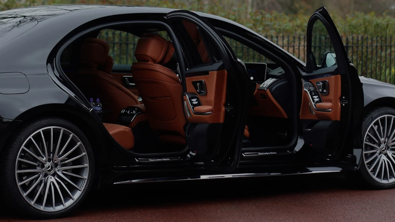 Business chauffeur service London executive travelling in the back of a Mercedes electric saloon