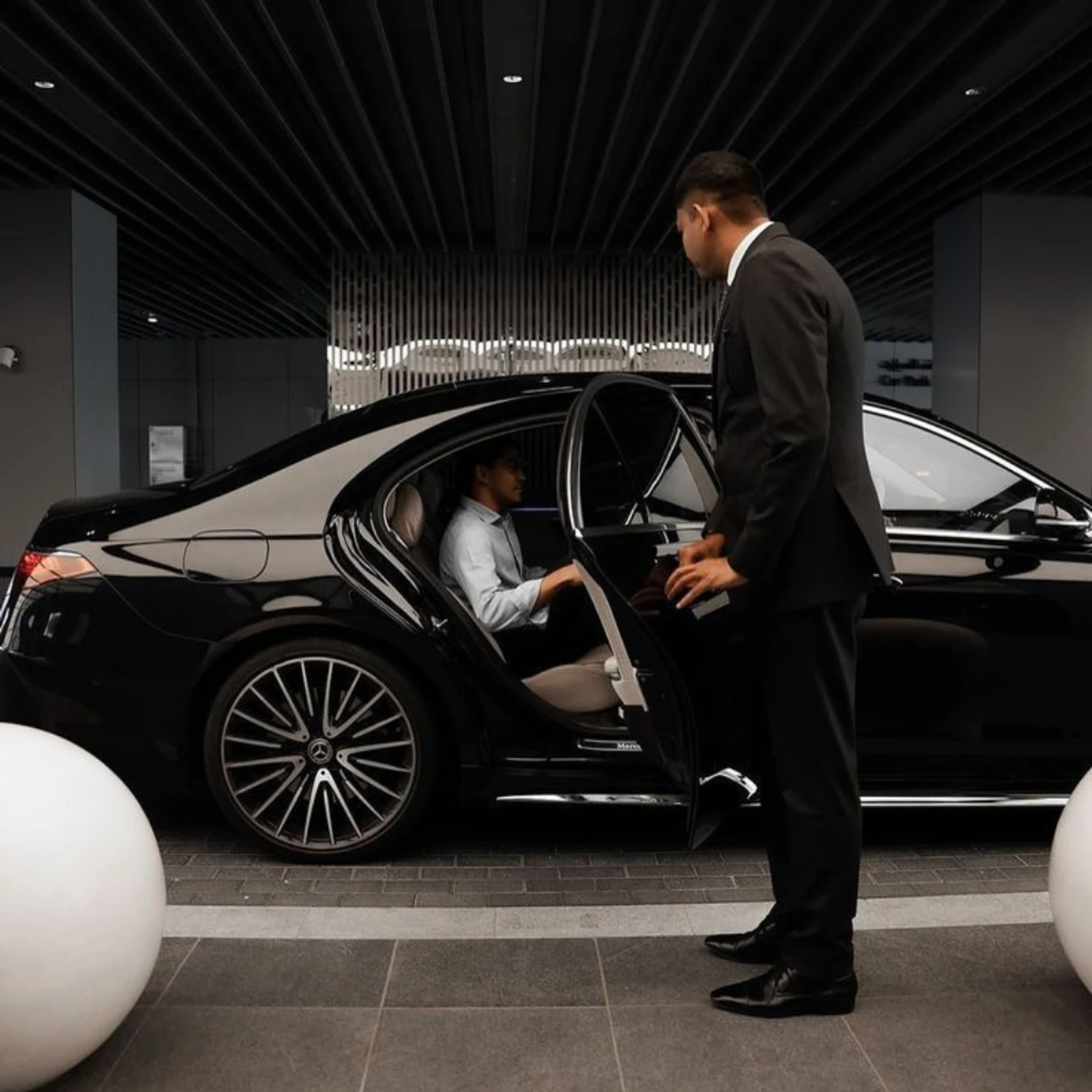 Electric Mercedes chauffeur car used for one way transfers at night