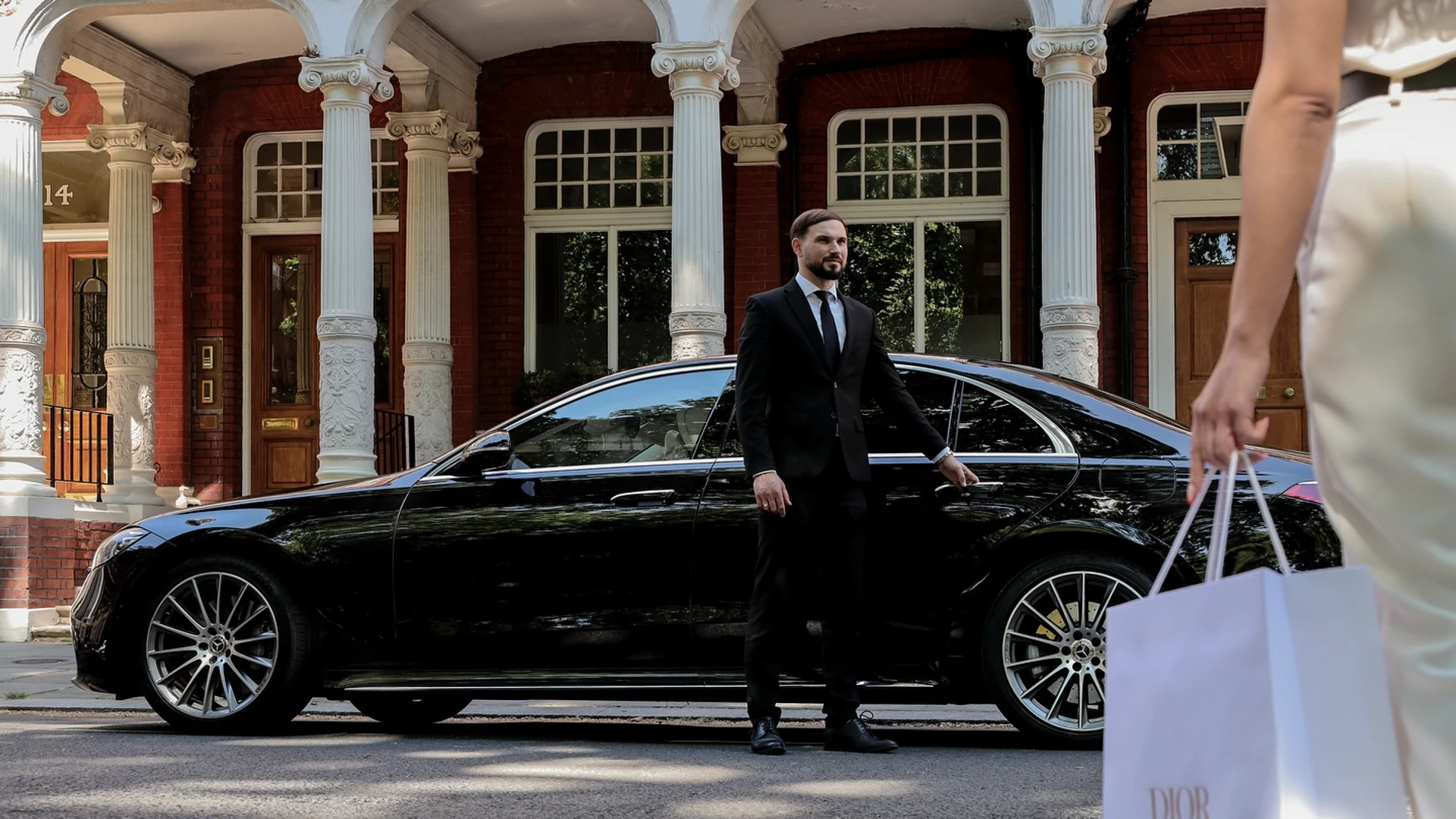 Private tour chauffeur car parked near an English countryside landmark
