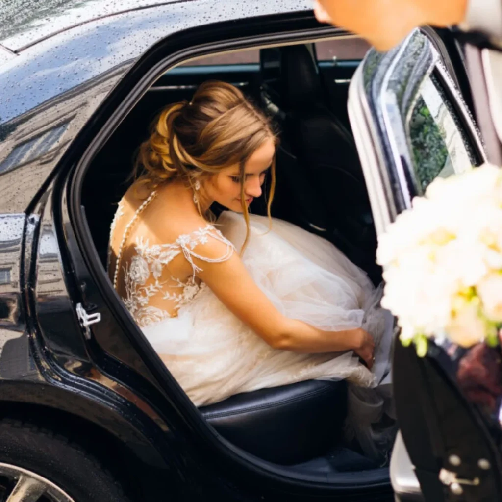 Elegant wedding car with chauffeur in Milton Keynes, decorated and ready for the bride and groom.