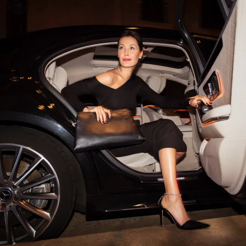 Luxury chauffeur-driven car parked at an upscale location, ready for executive or VIP travel.