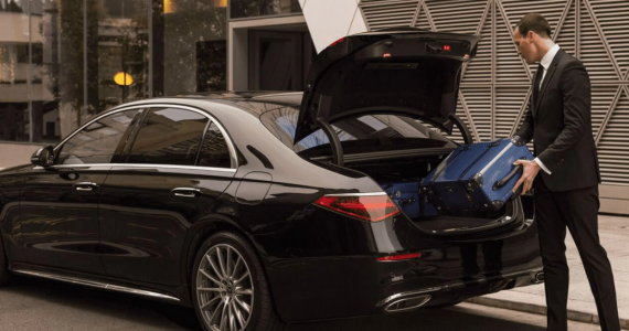 Chauffeur greeting client at Heathrow Airport arrivals